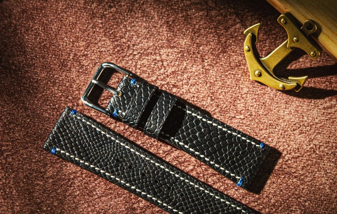 Leather watch strap flat lay with stitching detail