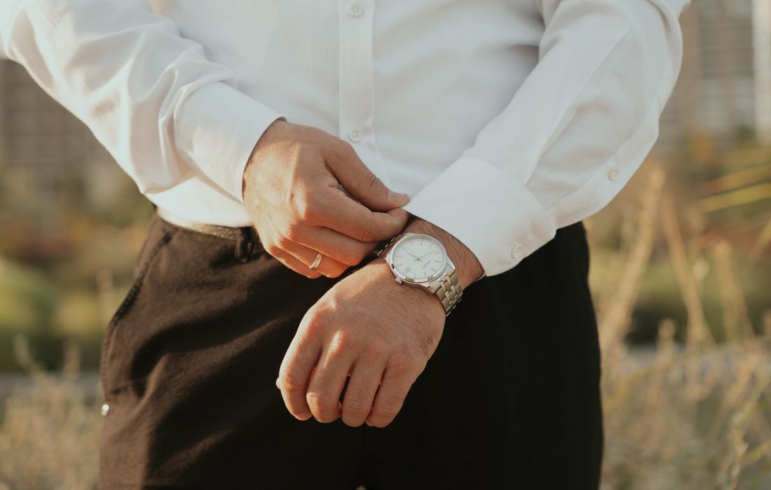 Man adjusting the strap of his wristwatch