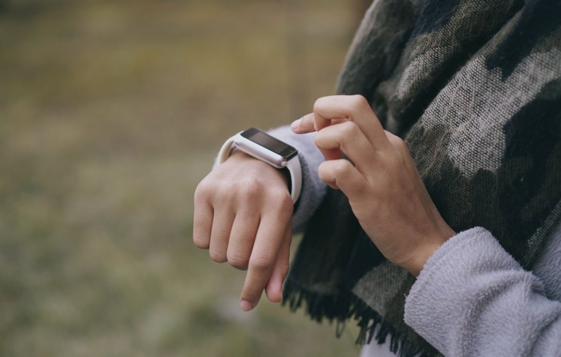 Person checking a sports watch outdoors