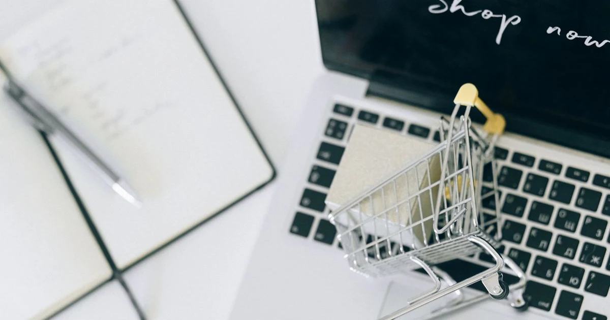 Online shopping cart on a laptop keyboard representing e-commerce compliance